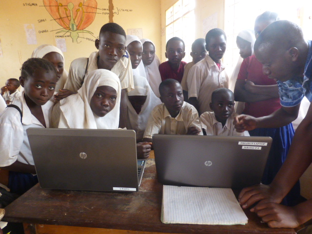 Students taking turns to work on the laptops